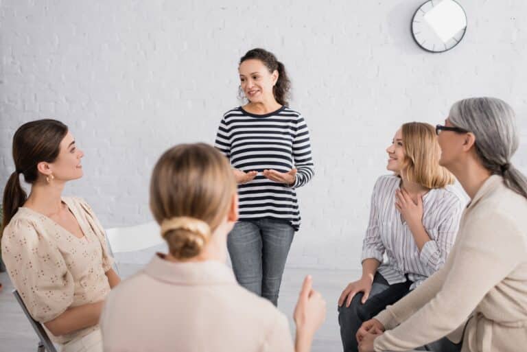 A group of diverse individuals engaging in a mental health workshop, promoting mental health awareness and well-being through community activities.
