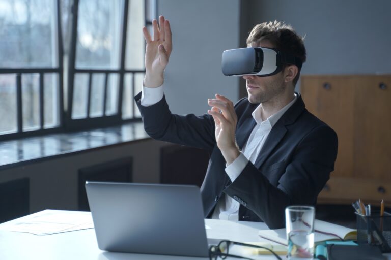 Male office worker using VR headset interacting with digital tools, symbolizing trust and accountability in a hybrid work team environment